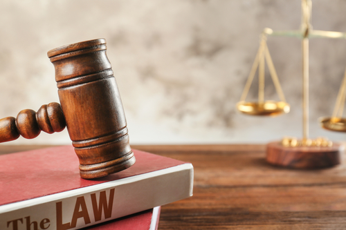 Court gavel with books, closeup