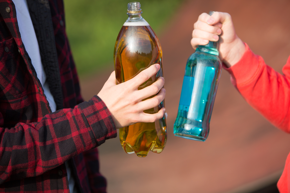 Close Up Teenagers Drinking Alcohol Together