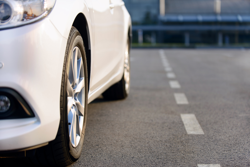 Feel the drive. Modern white car driving on the road