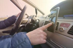 Woman using smort phone while driving the car