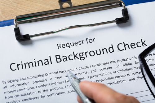 Hand Filling Criminal Background Check Application Form