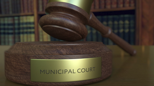 Judge's gavel hitting the block with MUNICIPAL COURT inscription. 3D rendering