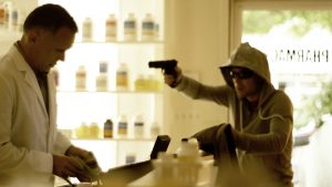 pointing gun at clerk