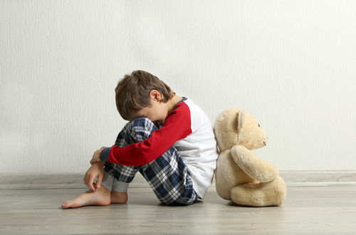 upset child with teddy bear
