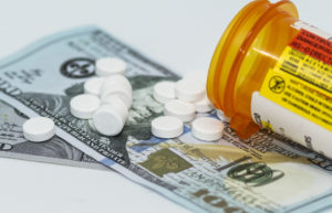 Oxycodone pills on 100 dollar bills