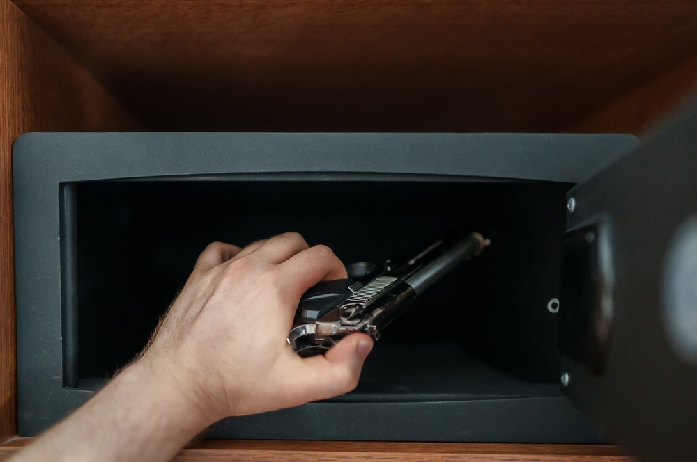 someone storing gun in safe