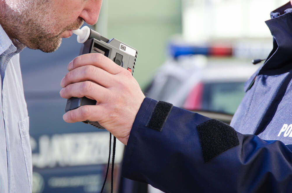 police officer during test for alcohol content with breathalyzer