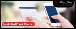 Woman hands holding credit card and using cell phone suggesting credit card fraud