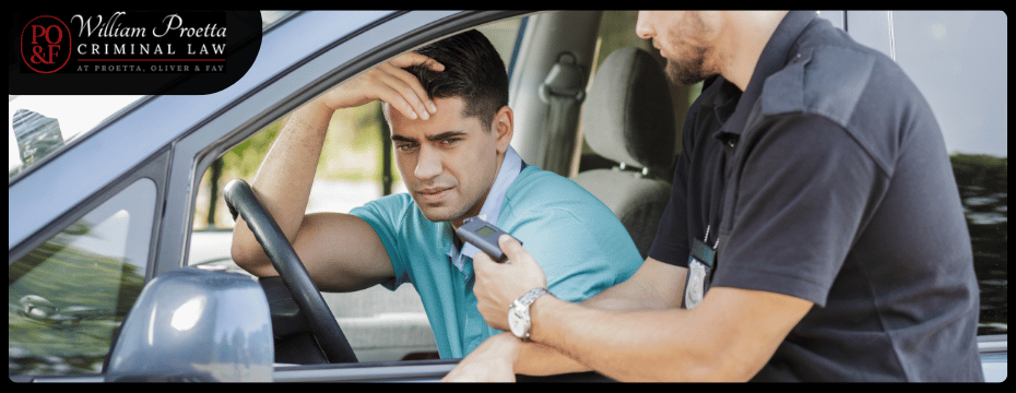 man in car distressed talking to an officer outside